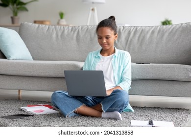 Concentrated Teen Afro American Female Student Studying At Home With Laptop, Preparing For Test, Exam, Doing Homework Or Watch Online Lesson. Remote Education, Device For Learning At Self Isolation