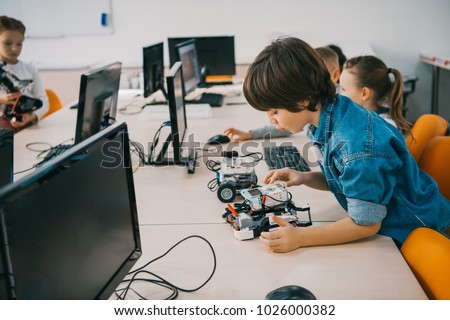 concentrated teen child constructing robot at class, stem education concept