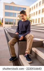 Concentrated Teen Working On His Portable Computer Outside