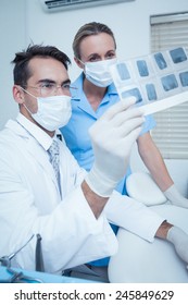 Concentrated Two Dentists Looking At X-ray