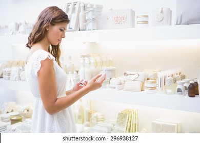 Concentrated Woman Reading Ingredients At A Beauty Salon