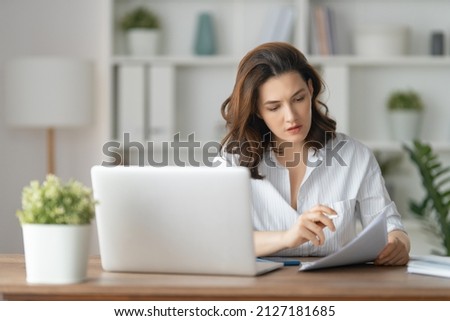 Concentrated woman working on a laptop in the office. Foto d'archivio © 