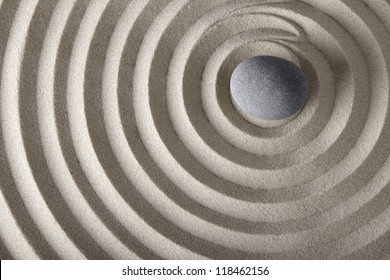 concentration and spirituality in Japanese zen garden spa background with stone and circles in sand concept for meditation and relaxation