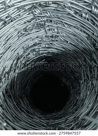 Concentric circles of sharp metal knots leading into a pitch black hollow cylindrical core