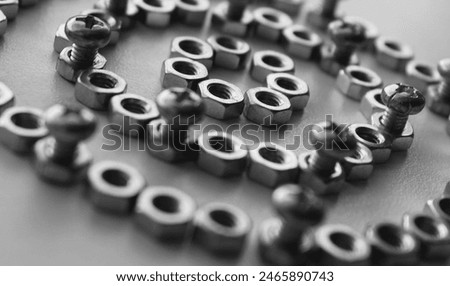 Concentric Pattern Of Circles Lined With Nuts And Inserted Through Equal Lengths Of Threaded Bolts. Monochrome Detailed Image For Mechanical Hardware Backgrounds 
