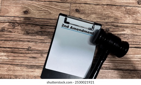 Concept of 2nd Amendment write on paperwork isolated on wooden background.