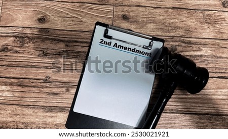 Concept of 2nd Amendment write on paperwork isolated on wooden background.