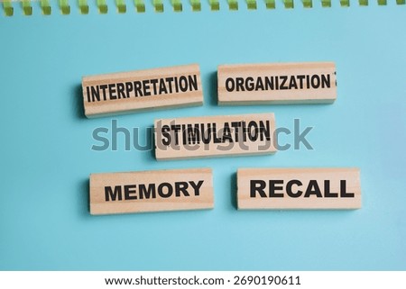 Concept of 5 processes of perception. Interpretation, organization, stimulation, memory, recall write on sticky notes isolated on Wooden Table.