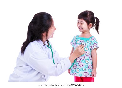 Concept About Children Health And Medical Care. Caring Medical Doctor Examining Asian Girl With Stethoscope, Woman Playing With Kids And Smiling Together. Studio Shot. Isolated On White Background.