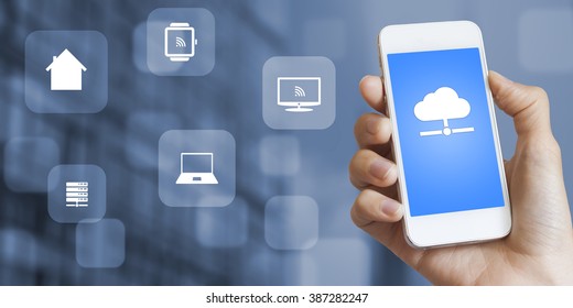 Concept about the technology of internet of things, female hand holding a smartphone connected to the cloud with online access to everything on the network