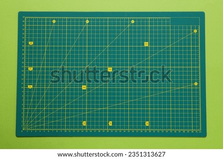 Concept of accessories for patchwork on a green background, mat cutting