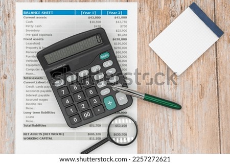 The concept of an accounting audit. calculator and magnifying glass on the financial statement and the annual balance sheet on the auditor's desk. Foto stock © 