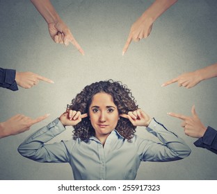 Concept of accusation of guilty businesswoman. Portrait unhappy sad upset woman plugging her ears many fingers pointing at her isolated grey office background. Human face expression emotion feeling - Shutterstock ID 255917323