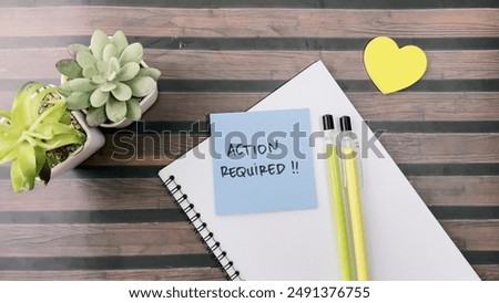 Concept of Action Required write on sticky notes isolated on Wooden Table.