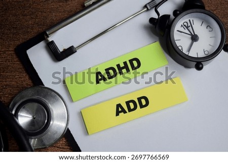 Concept of ADHD and ADD write on sticky notes isolated on Wooden Table.
