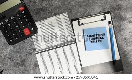 Concept of Adjusting Journal Entry write on sticky notes isolated on Wooden Table.