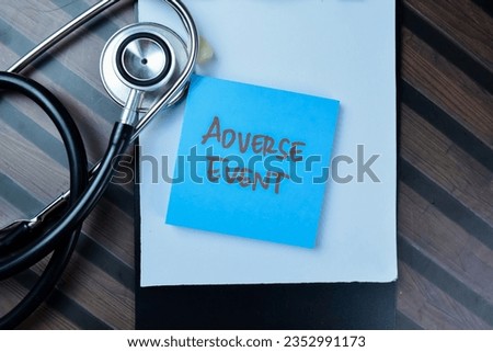 Concept of Adverse Event write on sticky notes with stethoscope isolated on Wooden Table.