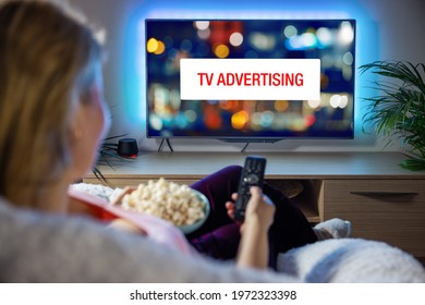Concept of advertising on television, woman looking at ad while watching TV