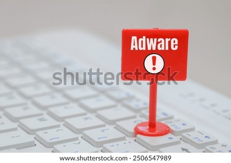 the concept of adware, a type of malicious software that displays unwanted advertisements, using a red sign with an exclamation mark to alert users about the potential threat.