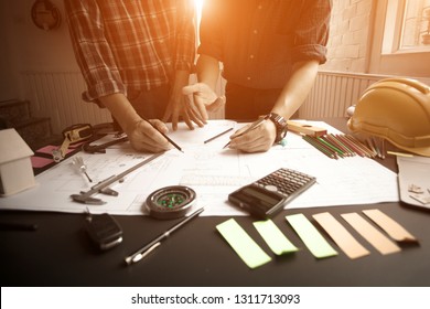 Concept Agreement between the employer and architect Nick and desk of Architectural project in construction site or office building with mining light - Shutterstock ID 1311713093