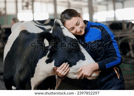 Concept agriculture cattle livestock farming industry. Farmer Happy young woman hugging cow, concept veterinary health care.