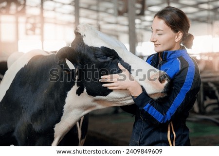 Concept agriculture cattle livestock farming industry. Happy young woman farmer hugging cow.