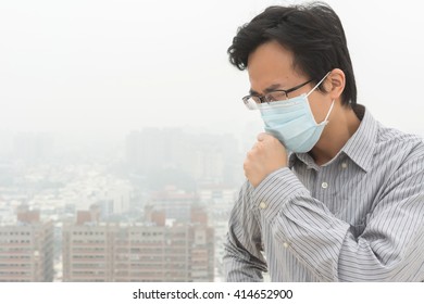 Concept Of Air Pollution With A Asian Young Man With A Mask