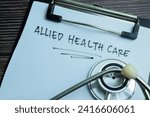 Concept of Allied Healthcare write on paperwork with stethoscope isolated on wooden background.