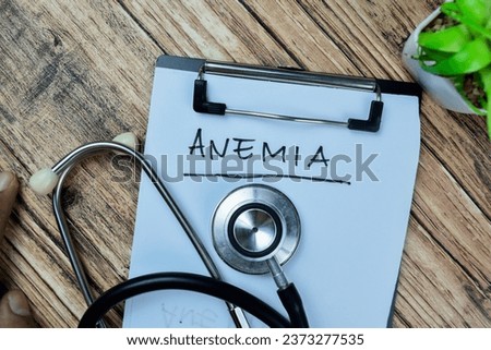 Concept of Anemia write on paperwork with stethoscope isolated on Wooden Table.