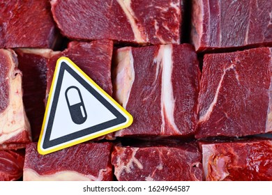 Concept For Antibiotics Residue And Antibiotic Resistance In Meat For Human Consumption, Showing Chunk Of Red Meat With Pill Warning Sign