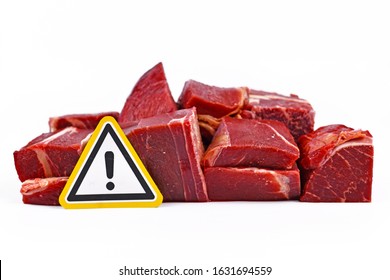 Concept For Antibiotics Residue And Harmful Bacteria In Meat For Human Consumption, Showing Chunks Of Red Meat With Yellow Warning Sign