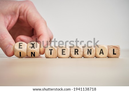 Concept of antonym external and internal on wooden blocks.