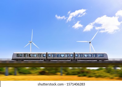 Concept Application Green Energy In Transport. Side View At Metro Train Is Which Passing At Overpass Railroad Over Parkland With Windmills.