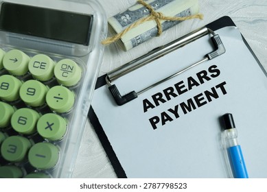 Concept of arrears payment write on clipboard isolated on Wooden Table.
