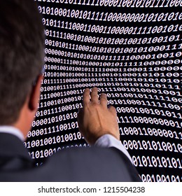 Concept of artificial intelligence and machine learning. The man ilooks at the binary code of the digital world.