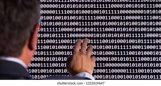 Concept of artificial intelligence and machine learning. The man looks at the binary code of the digital world.