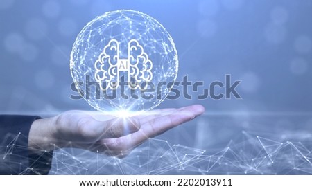 The concept of artificial intelligence technology or AI.
There is an abstract brain circuit within a sphere formed by interconnected polygons, placed on a hand against a blue background.