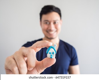 Concept Of Asian Man Buy A House With Small Model House In Hand.