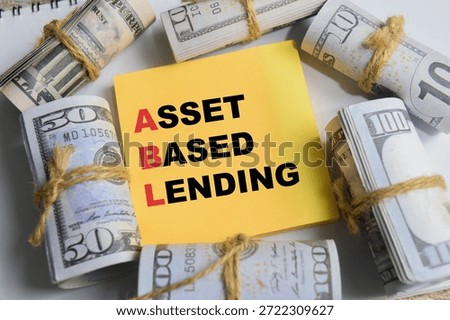 Concept of asset based lending write on sticky notes isolated on Wooden Table.