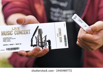 Concept for attending concerts during Corona Virus pandemic with hand holding made up ticket and SARS-CoV-2 rapid antigen test with negative result 