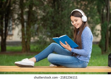 Concept Of Audiobook. Teen Girl Reading And Listening To Audiobook. Self Education With Audiobook