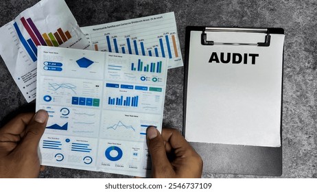 Concept of Audit write on paperwork isolated on Wooden Table.