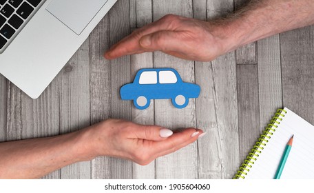 Concept Of Auto Insurance With Hands In A Protective Gesture