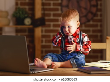 Concept Of Baby Boy Working On A Computer And Talking On The Phone
