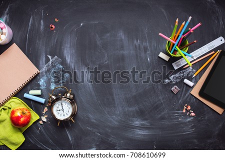 Concept Back To School Alarm Clock Color Chalk Pencil Apple Notebook Stationery on Black Blackboard Background. Design Copy Space Supplies Top View Flat Lay