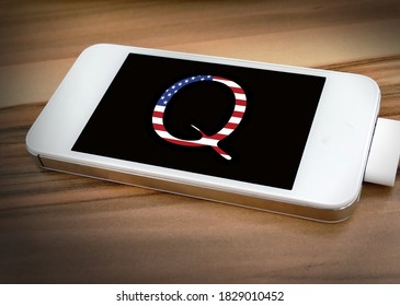 Concept Background For Illustration For QAnon Or Q Anon, A Deep State Conspiracy Theory. Letter Q With US Flag,against Black Background On Smartphone