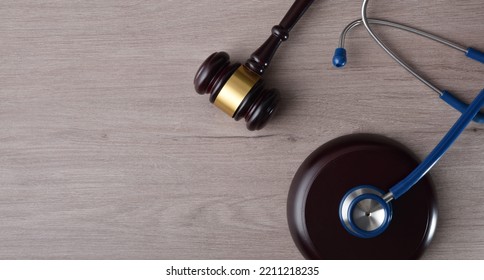 Concept Background Of Justice In Health And Health In Fair Justice With Gavel And Stethoscope On Wooden Table. Top View.