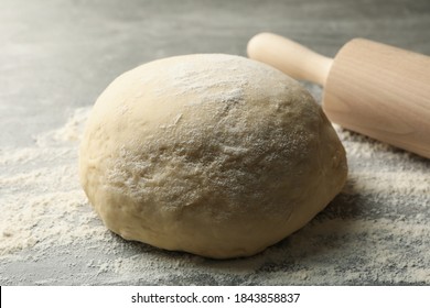 Concept for baking with dough on gray background