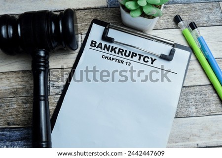 Concept of Bankruptcy Chapter 13 write on paperwork isolated on wooden background.