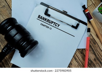 Concept of Bankrupty Chapter 13 write on paperwork isolated on Wooden Table.
